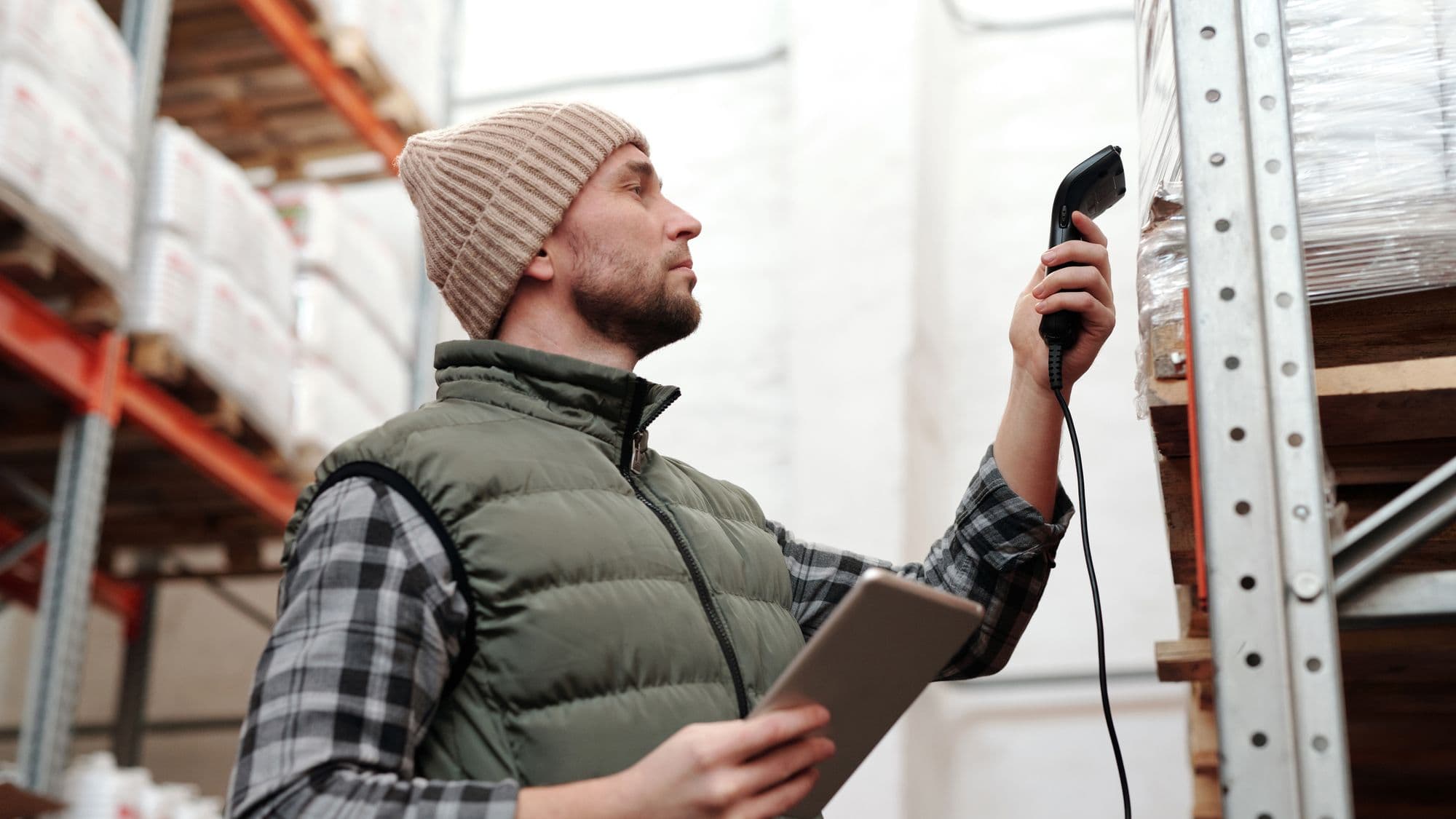 A warehouse worker scanning inventory with a handheld device