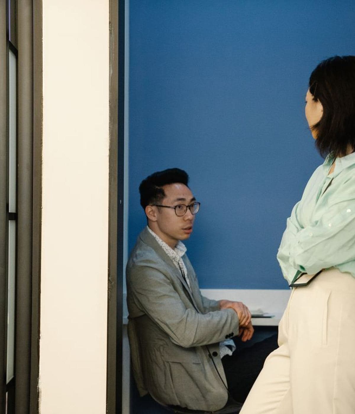 Two colleagues talking in a doorway