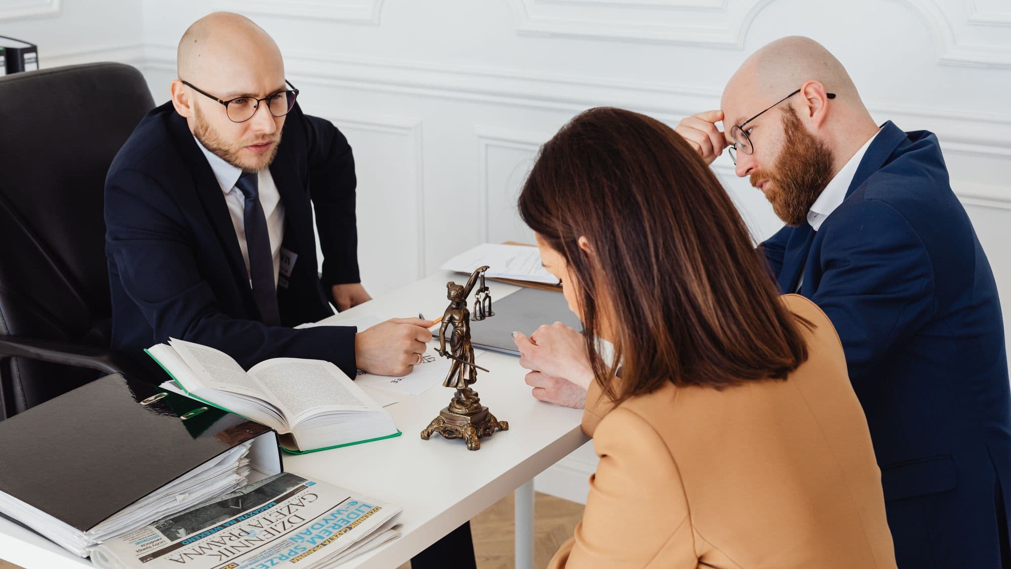 Two solicitors in discussion with a client in an office