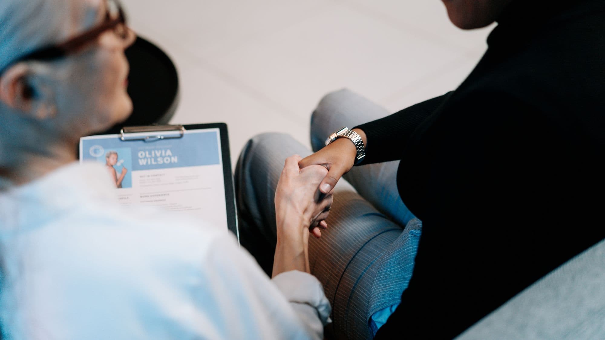 Two professionals shaking hands in an office
