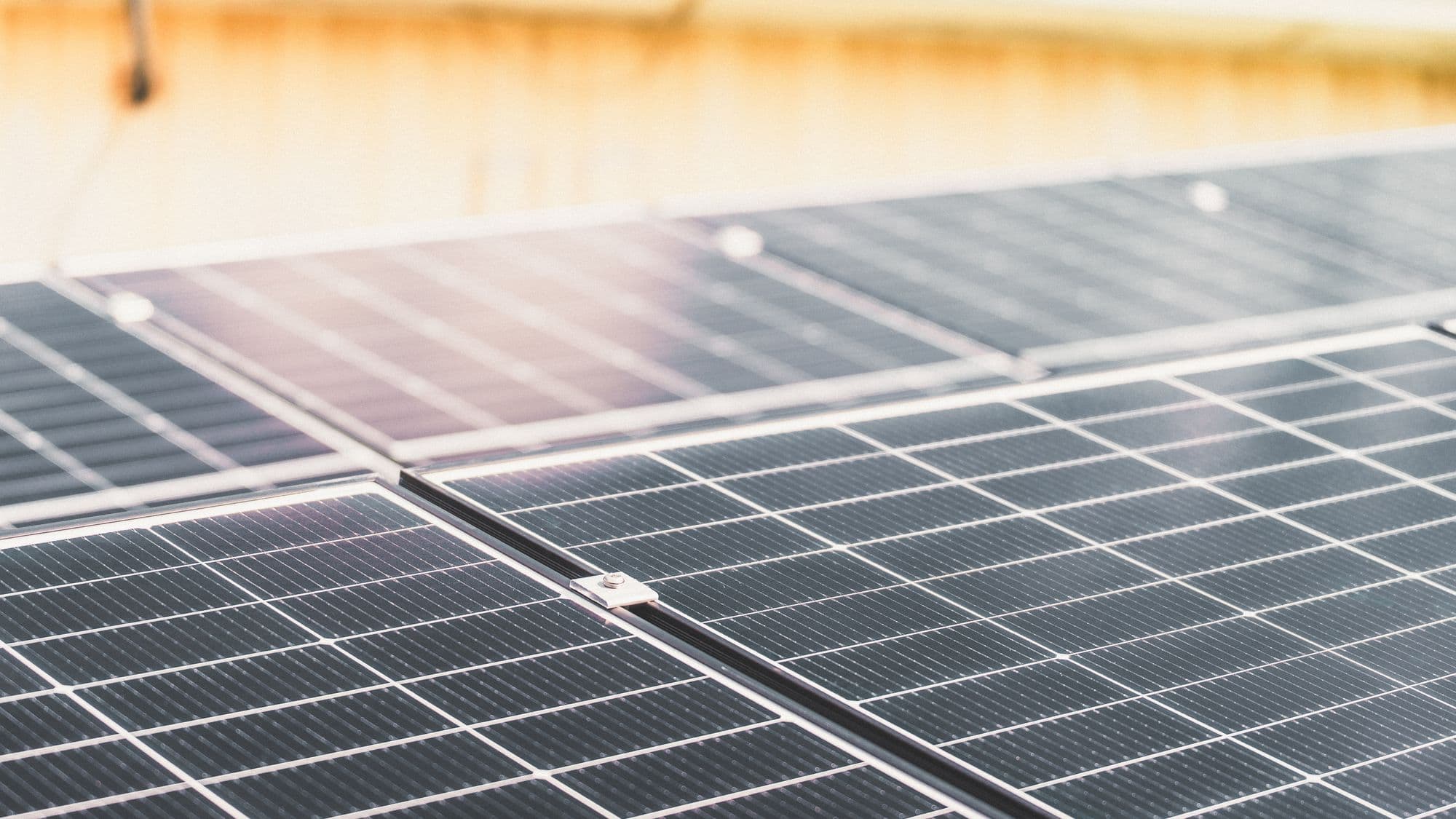 A completed solar array across a roof in full sun