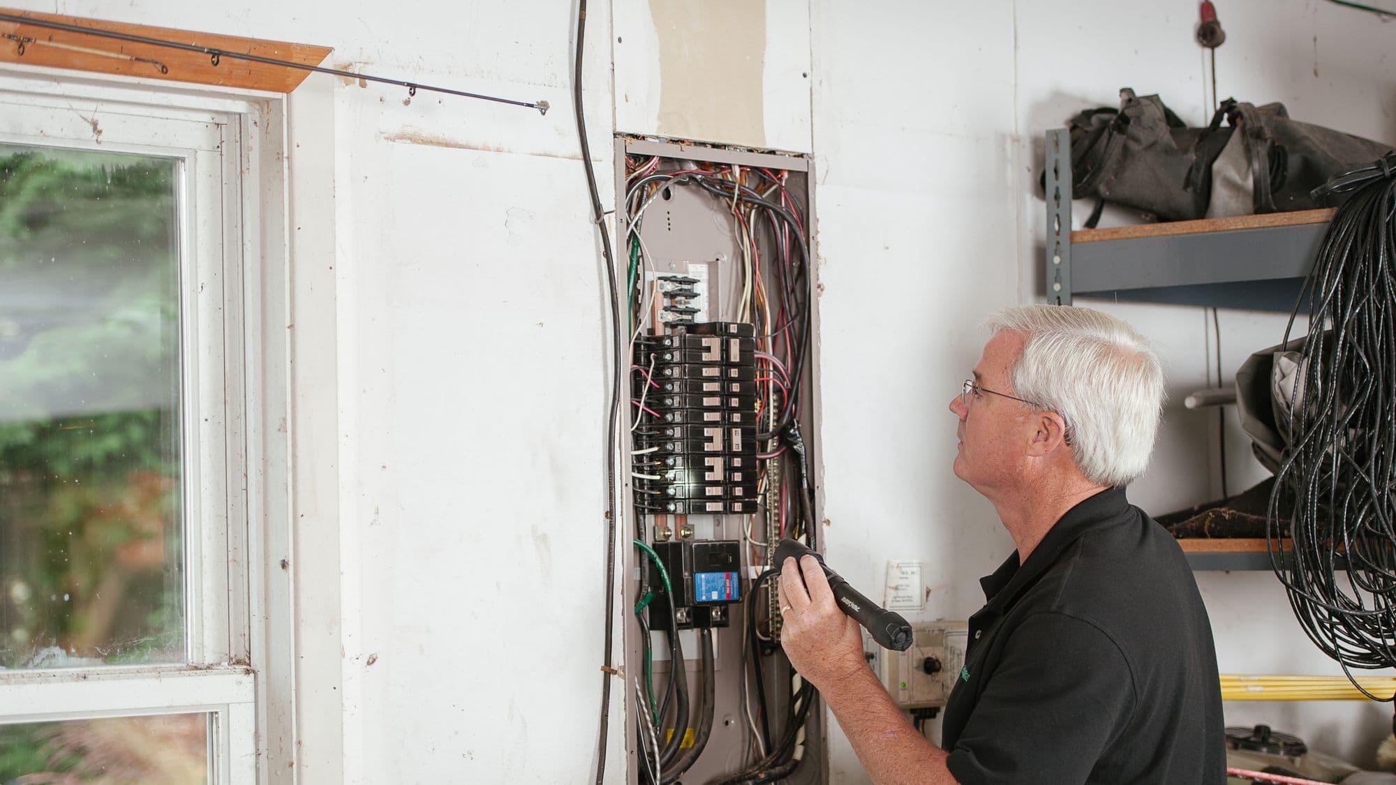 An engineer checking the breakers in a domestic consumer unit