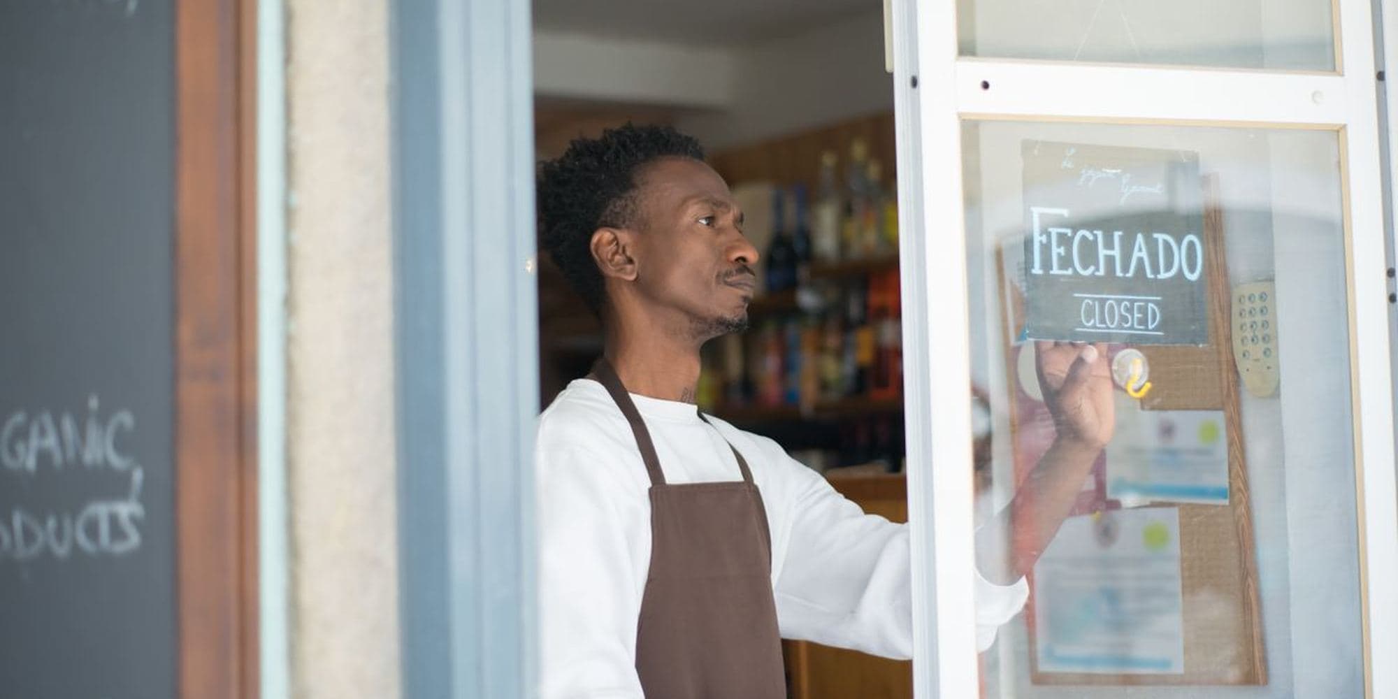 A shopkeeper opening up for the day