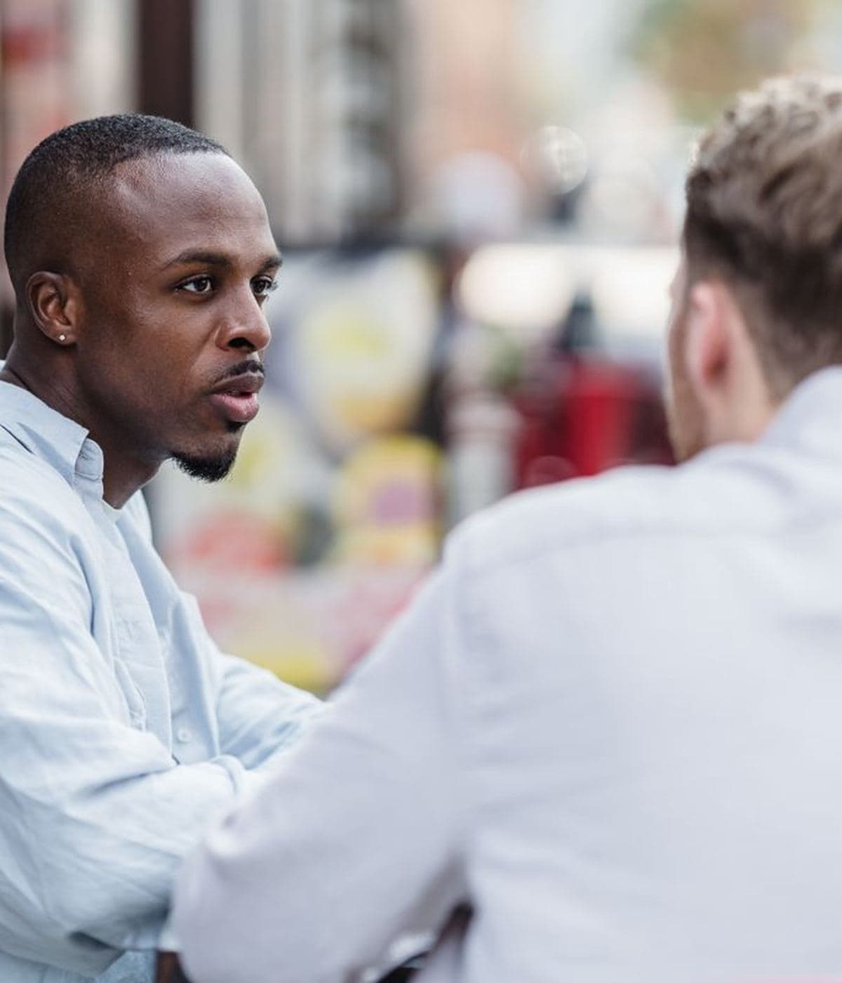 Two people talking outside, mid conversation