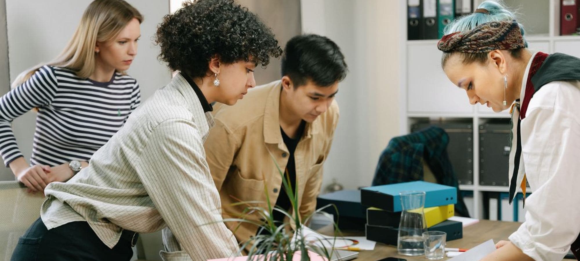 Colleagues working together over notes and a laptop