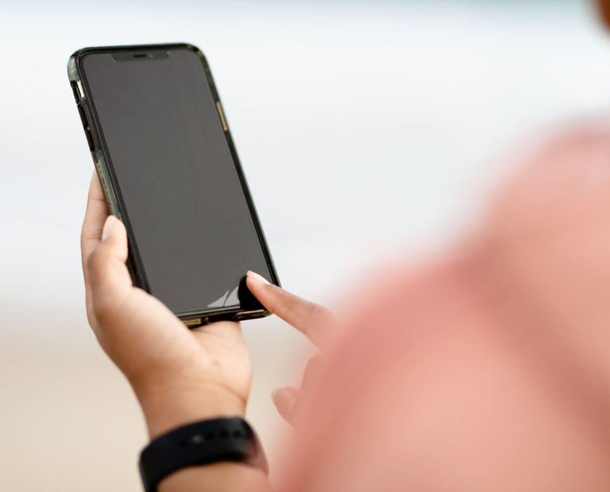 A phone held in one hand with an app open on the screen