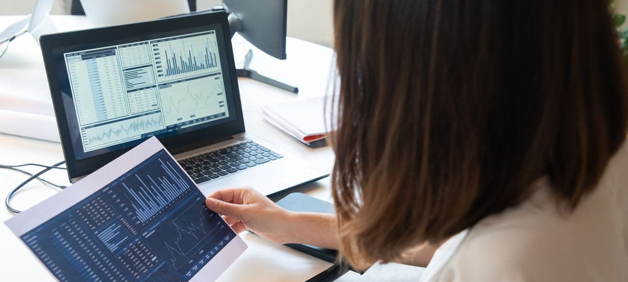 Someone reading a dashboard on two screens at a desk