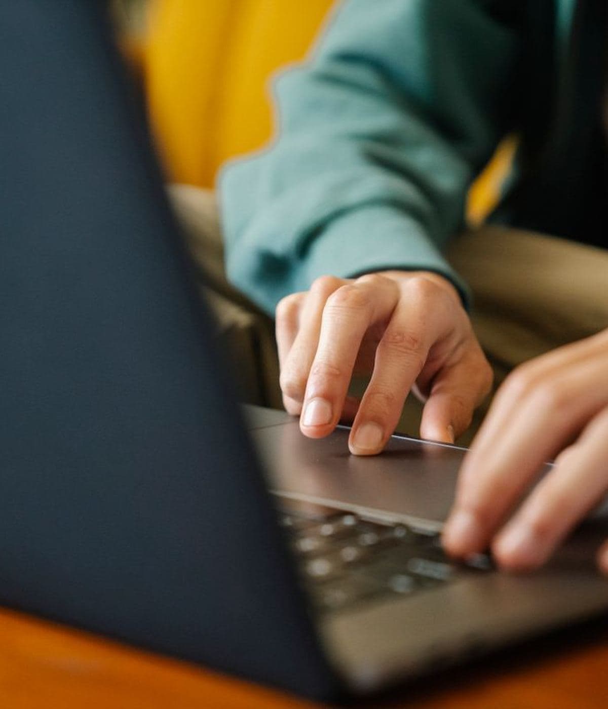 Someone working at a laptop in a bright room